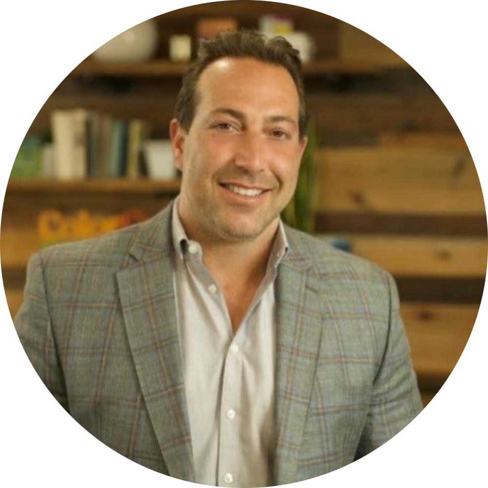 An executive-style portrait of George Scorsis in a dress shirt and sport coat.